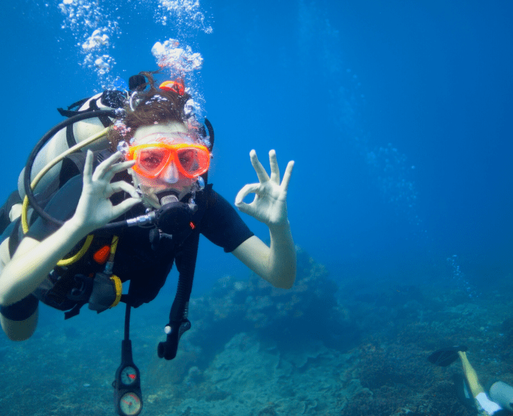young woman scuba diving in the ocean