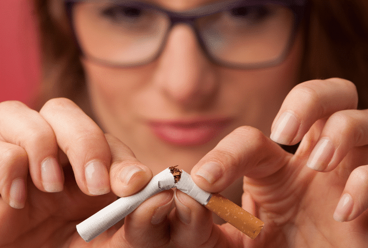 woman breaking cigarette stoping smoking