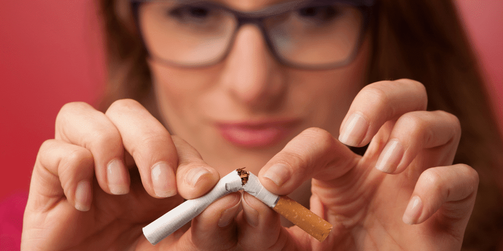 woman breaking cigarette stoping smoking