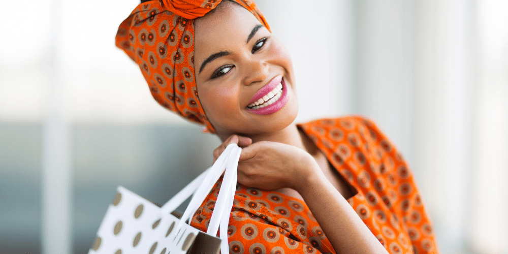 happy black woman shopping to boost her mood