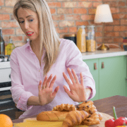 blonde woman scared of food in her kitchen leaky gut syndrome