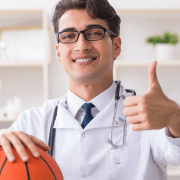 young male physician specializes in treating athletes and sports injuries