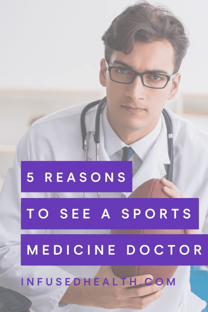 Young sports medicine physician holding football