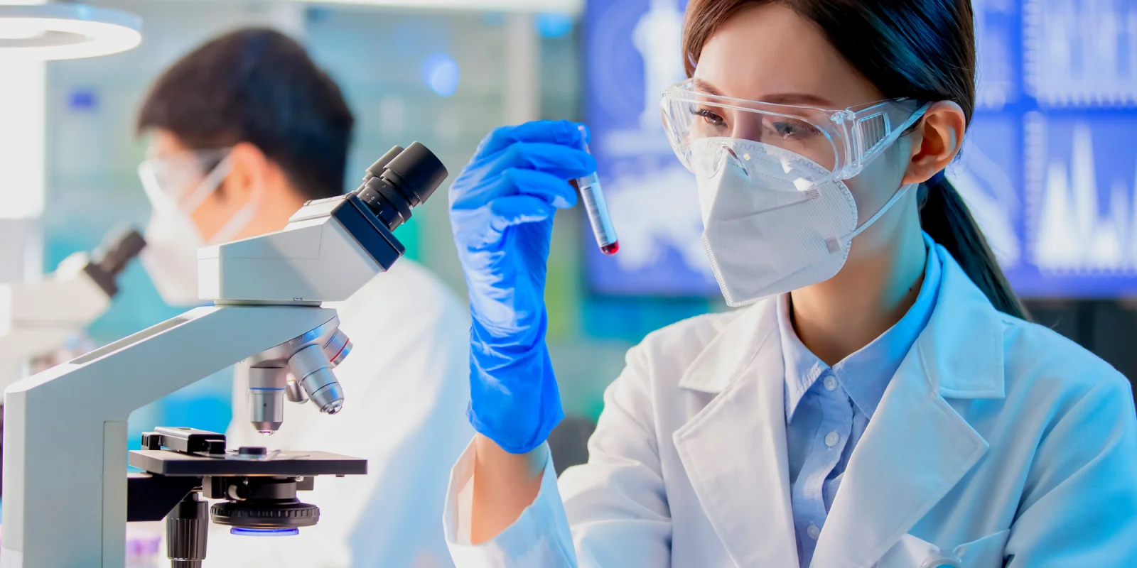 young asian scientist studying c-protein blood test