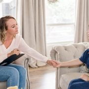 woman therapist helping depressed asian patient